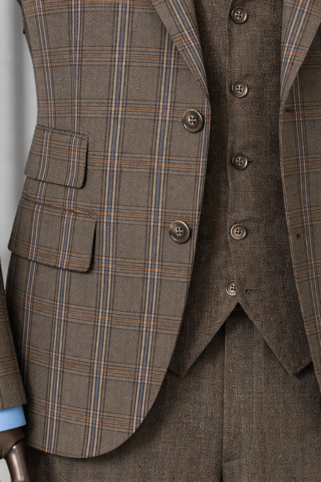 Men’s brown plaid slim-fit 3-piece suit with peak lapel blazer, matching vest and trousers, styled for formal and smart occasions with a modern tailored silhouette.