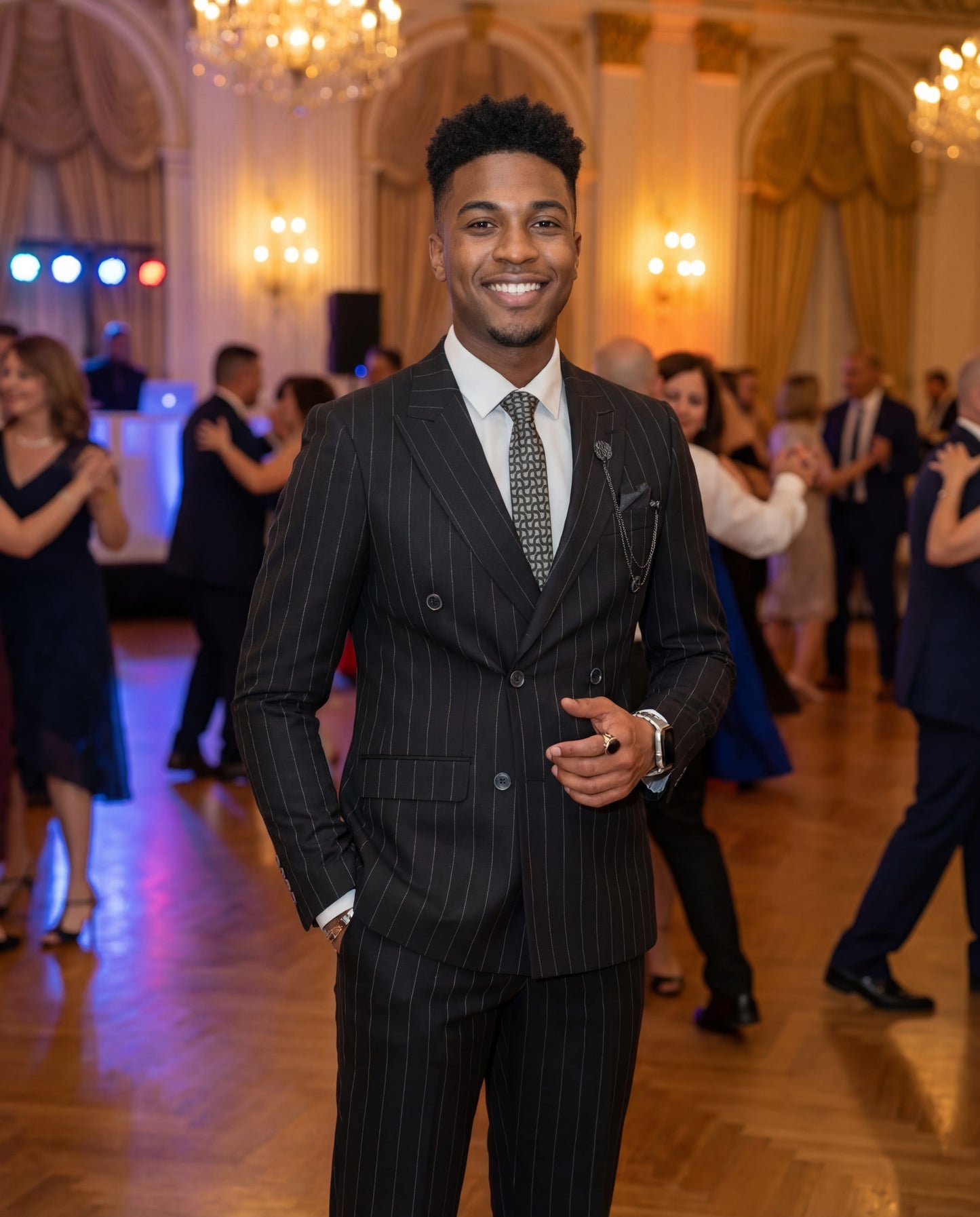 Black double-breasted pinstripe prom suit worn by young male model at formal event