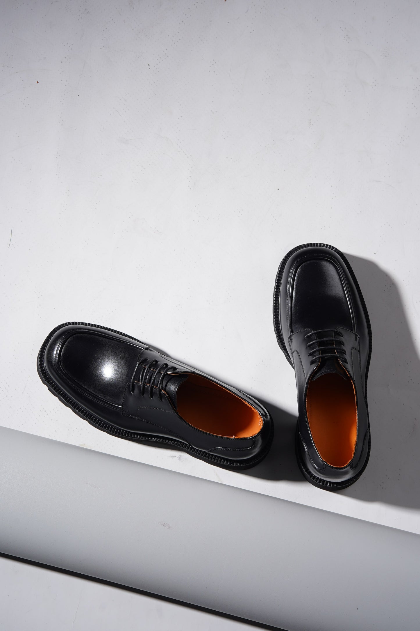 Pair of Luxury Chunky Derby Shoes angled to highlight chunky sole and polished leather upper.