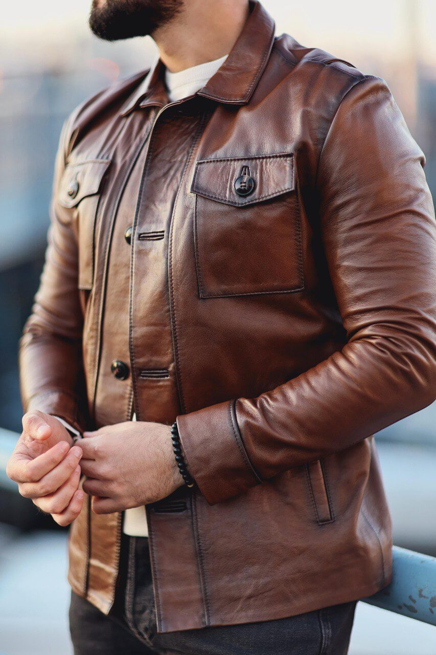 Camel leather overshirt close-up showing chest pocket and button detail
