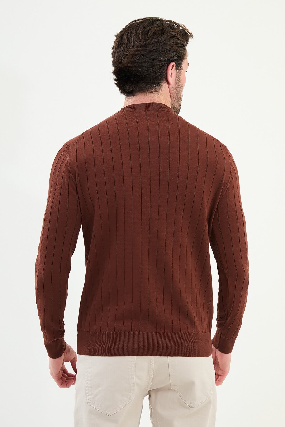 Model wearing AXIST tile brown ribbed knit sweater with beige chinos