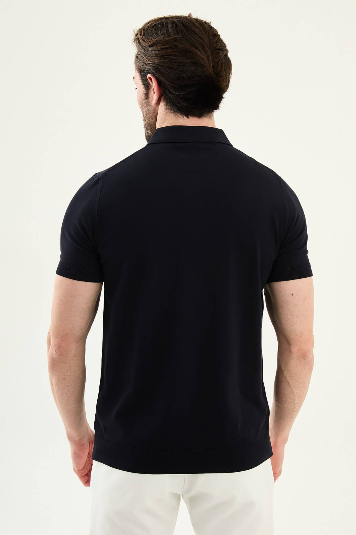 Men’s navy blue slim fit cotton polo shirt with short sleeves and stretch fabric, clean modern casual style