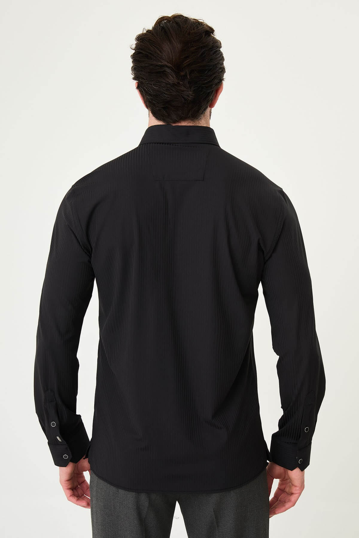 Men wearing a black textured slim-fit long sleeve striped shirt, styled for smart-casual summer wear.