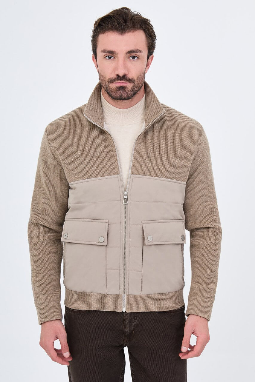 Beige men's casual jacket styled with a cream sweater and dark trousers.