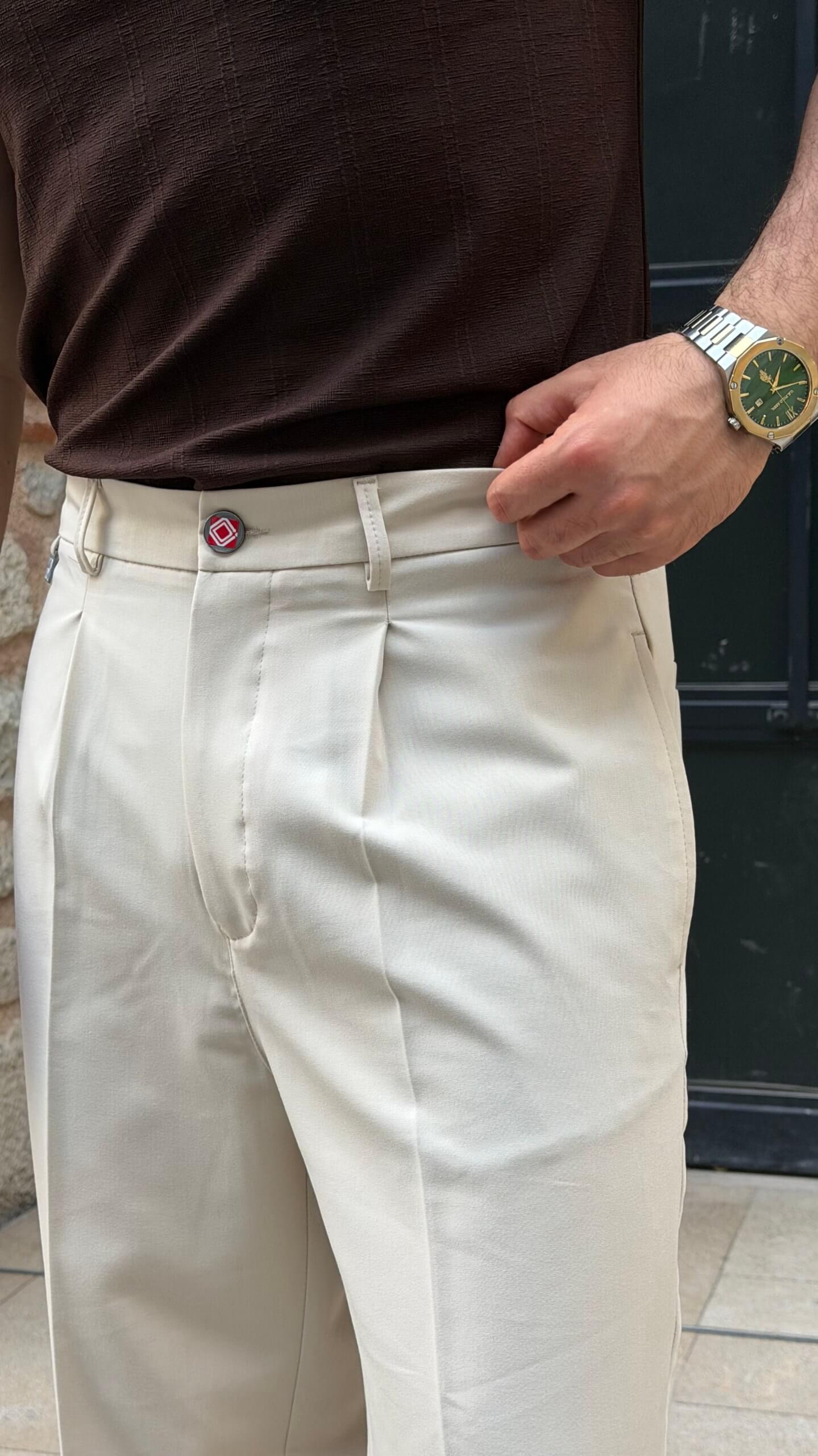 Beige pleated trousers styled for smart casual wear, full outfit view