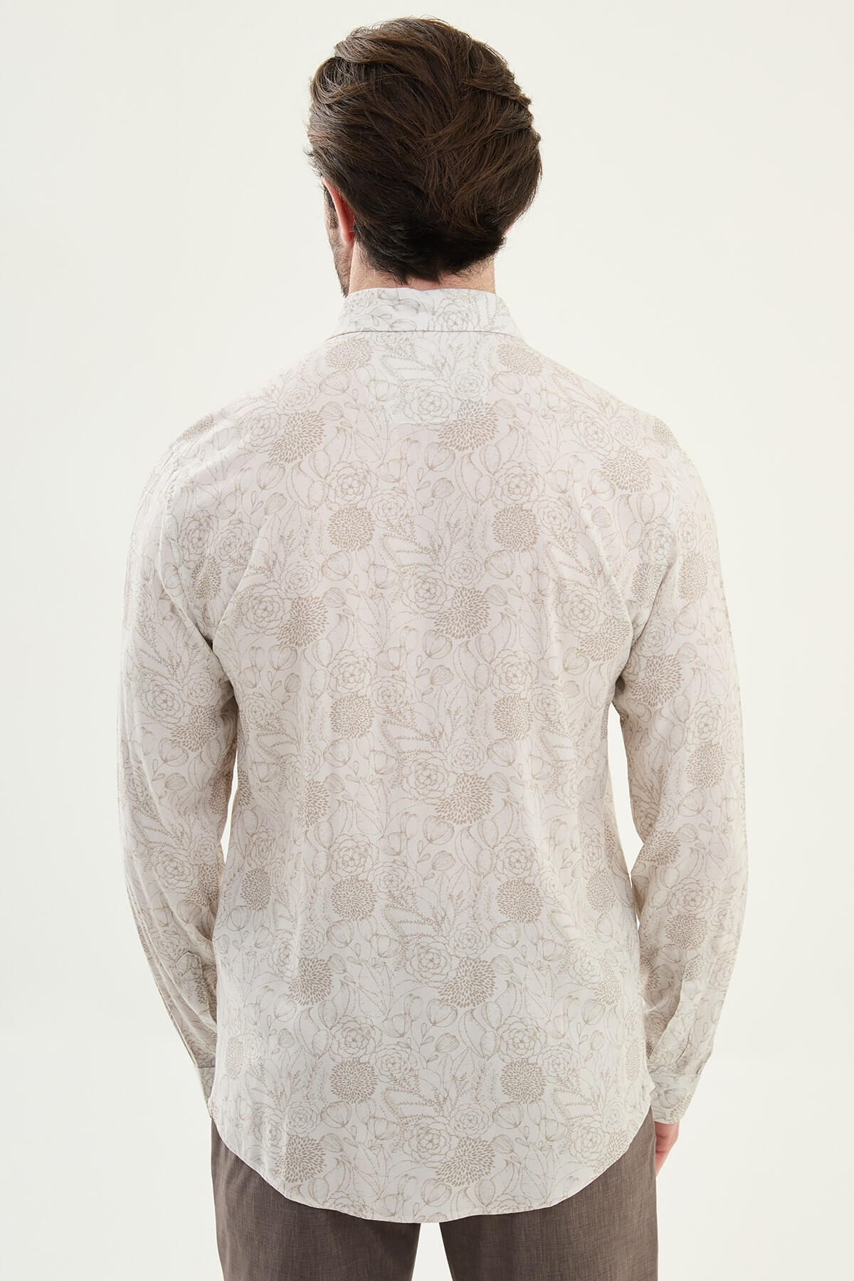 Men wearing a beige floral patterned slim-fit shirt, long sleeves, standing straight against a plain background