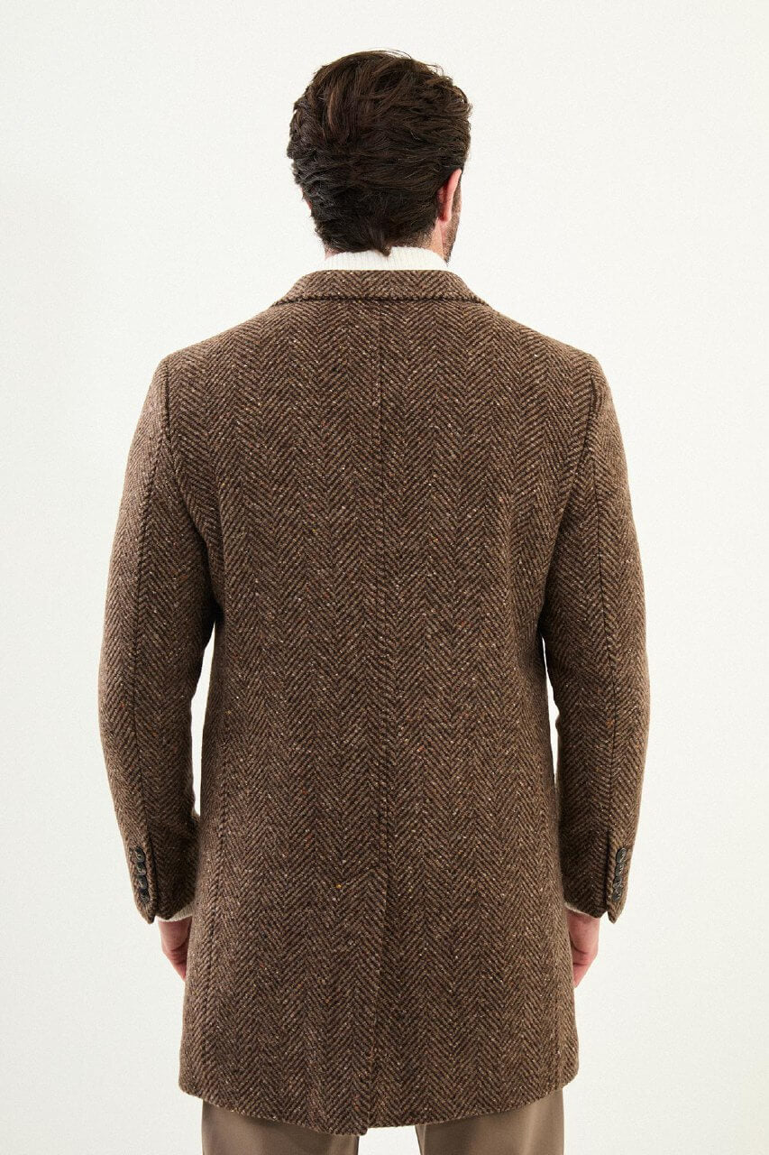 Beige herringbone wool blend men’s coat styled with cream knit sweater