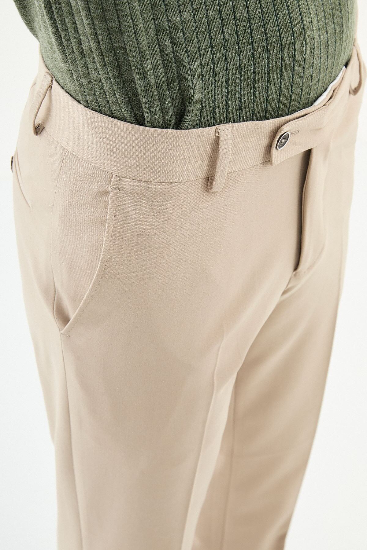 Beige slim-fit formal trousers with subtle pleats, styled with dress shoes, perfect for summer smart-casual and formal occasions.