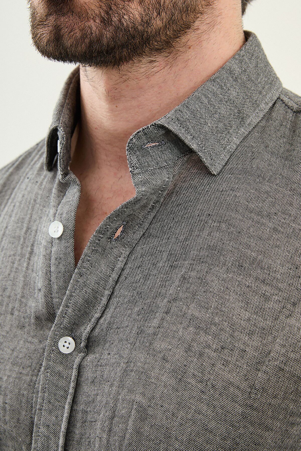 Men’s grey cotton long sleeve button-down shirt with a lightweight textured finish, styled for smart casual spring and summer outfits.