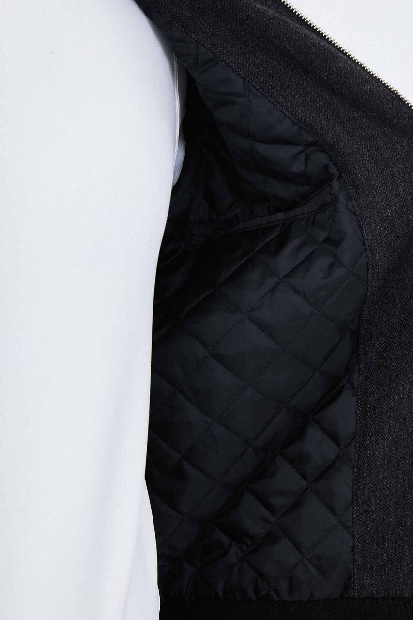 Black wool-blend men's jacket styled with a white T-shirt and black trousers.