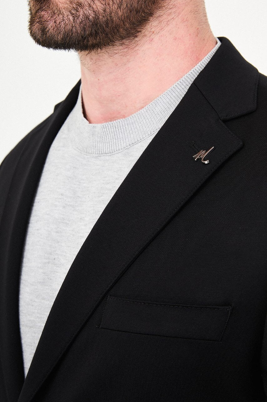 Men's black slim-fit casual suit with a two-button blazer, notch lapels and front patch pockets.