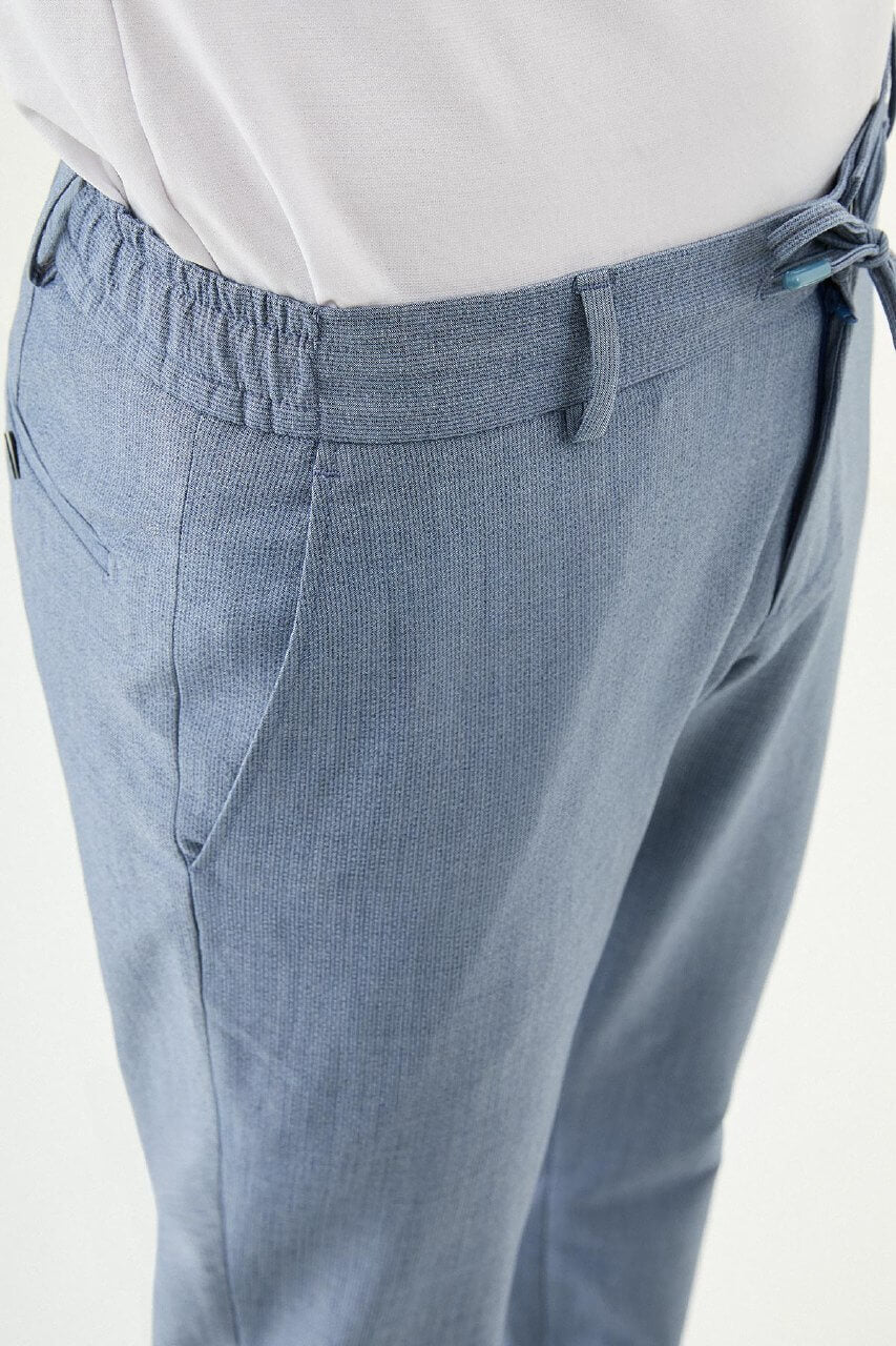 Man wearing blue slim-fit summer trousers