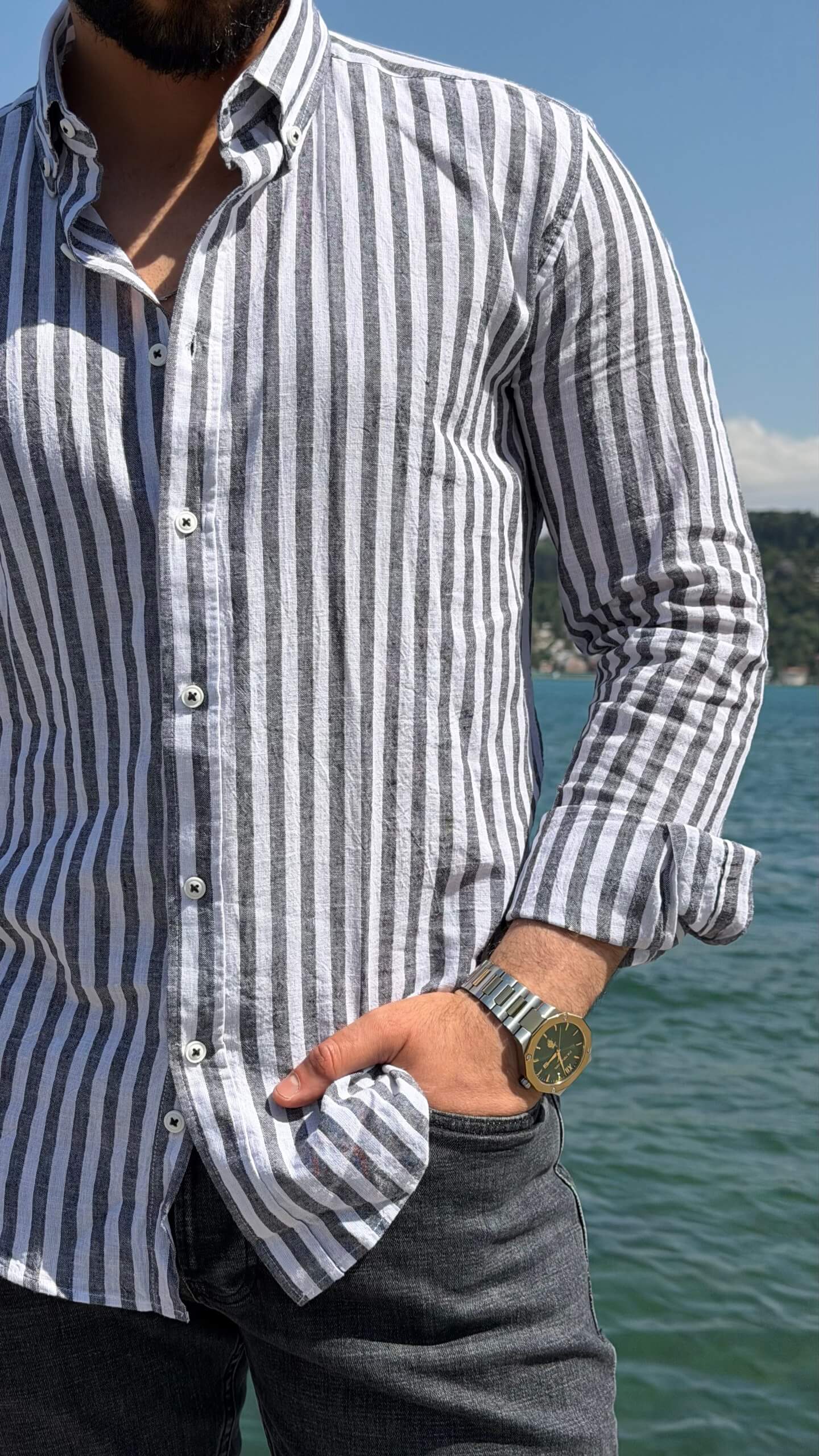 Blue and white striped men's shirt styled with chinos, back view