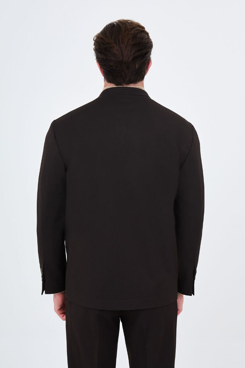 Men's brown slim-fit suit featuring a collarless V-neck jacket and single-button fastening.