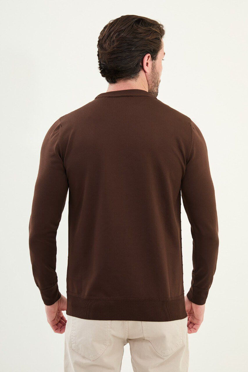 Men’s slim-fit chocolate brown crew-neck sweater with geometric ‘T’ textured knit front panel, cotton-viscose-elastane blend, styled with cream trousers.