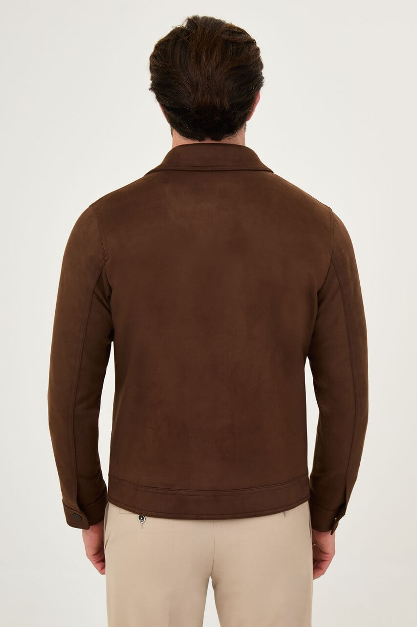 Men's brown suede-style jacket paired with a black sweater and beige trousers.