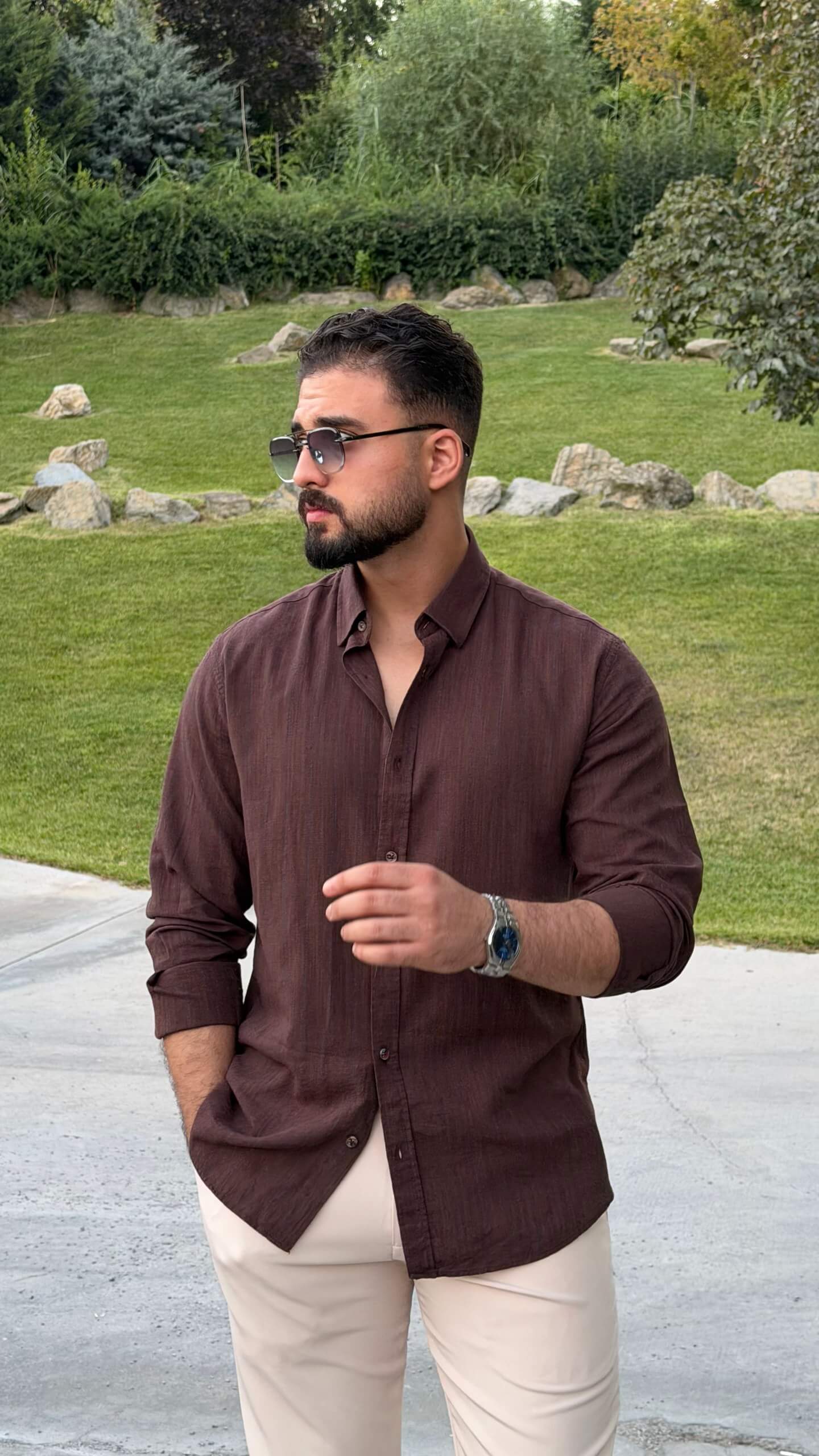 Men’s brown textured cotton long sleeve casual shirt styled with cream trousers and loafers