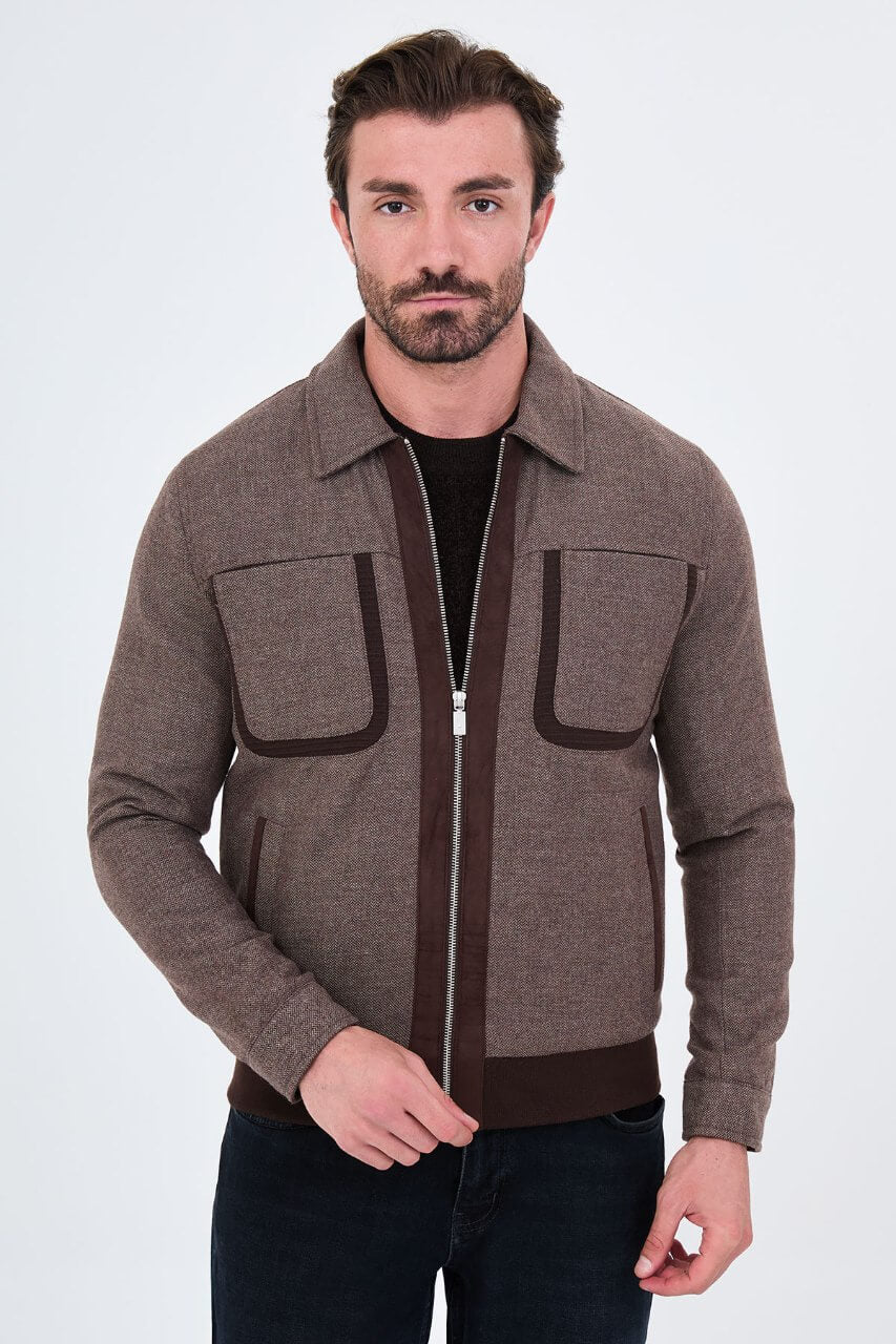 Brown men's casual jacket styled with a black sweater and dark jeans.