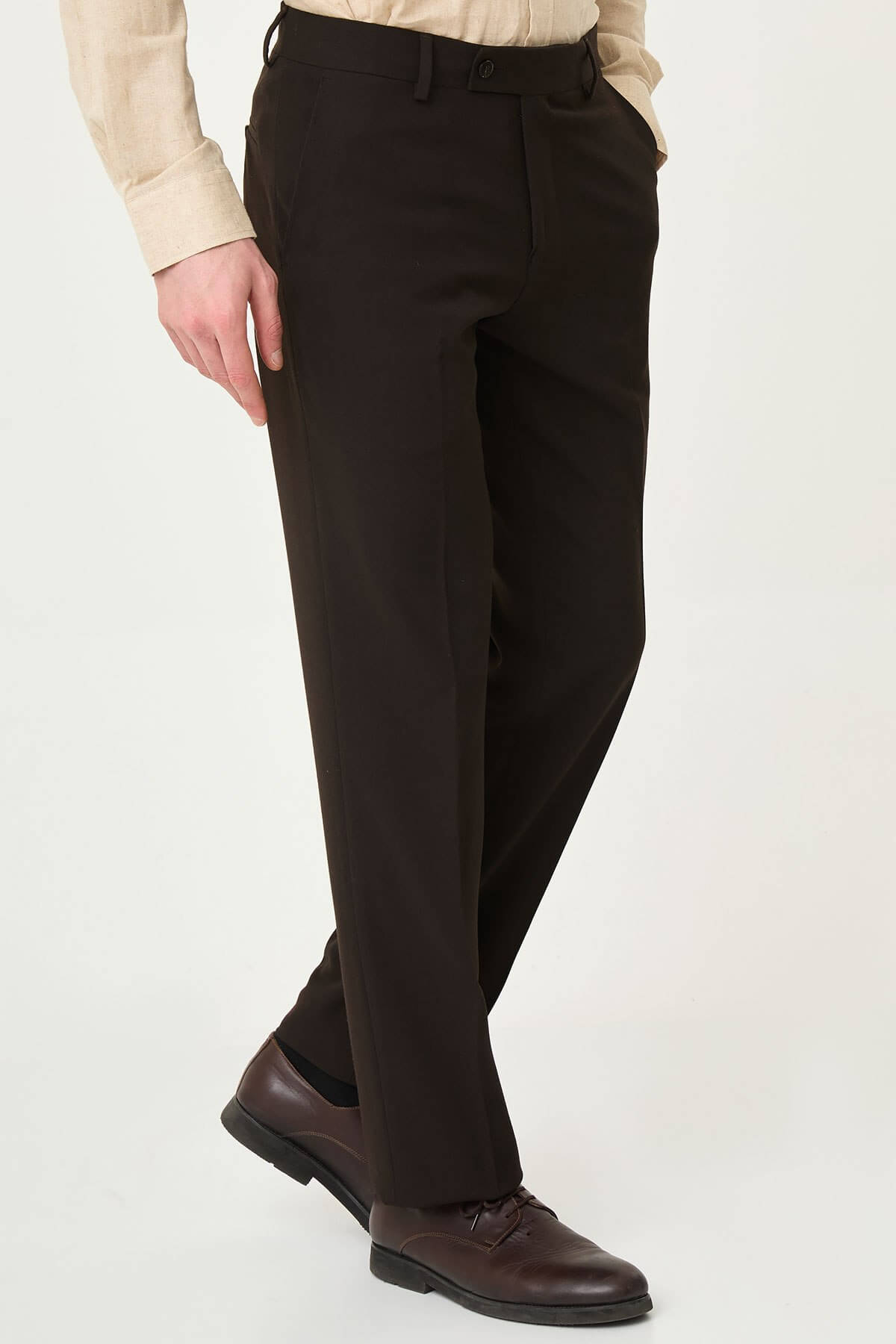Dark brown slim-fit formal trousers with front pleats, paired with brown leather shoes.