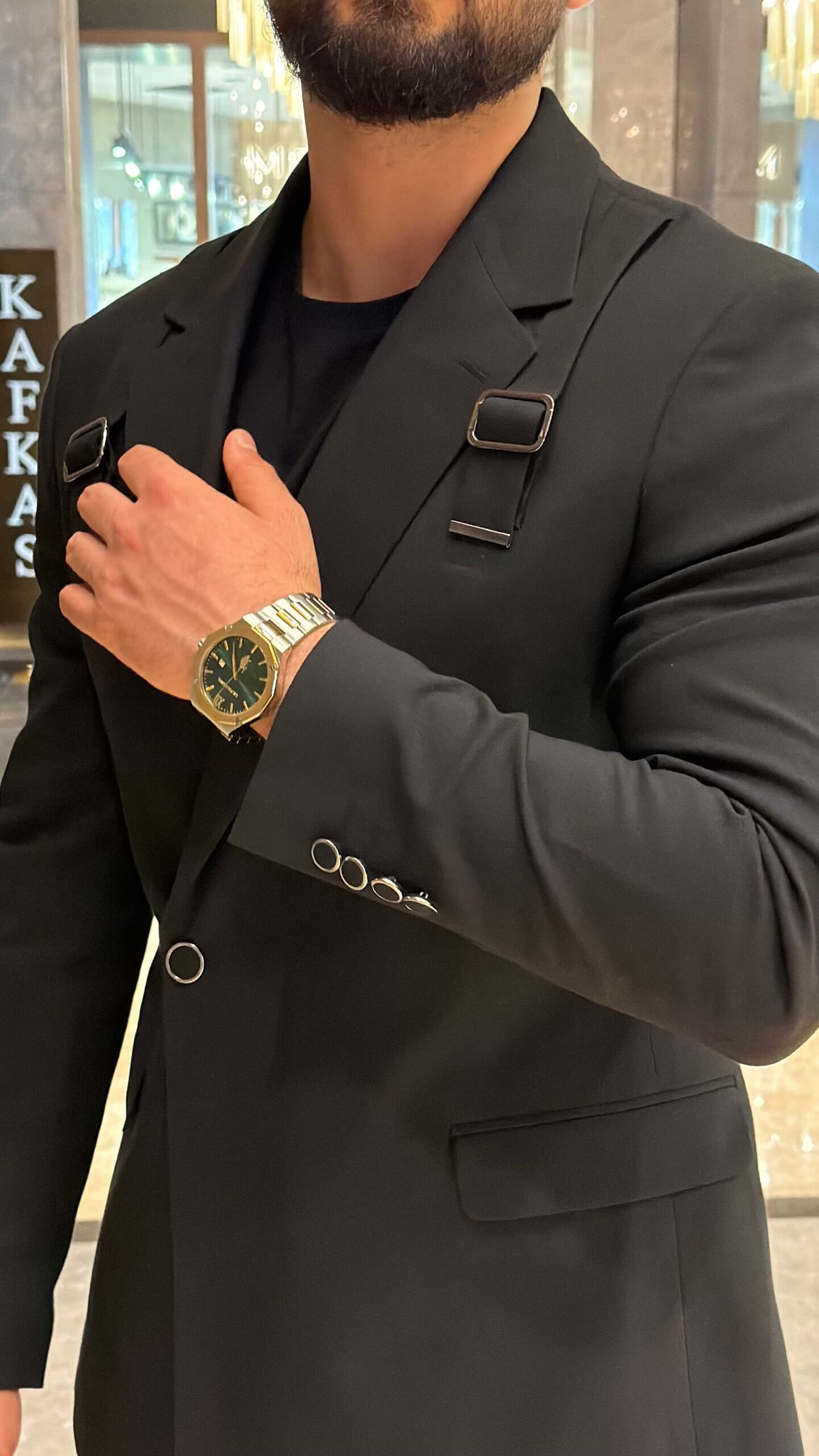 Men's black tailored fashion suit with modern strap detail styled with black T-shirt