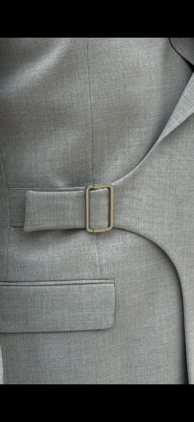 Light gray slim fit men’s suit styled with black loafers and black t-shirt.