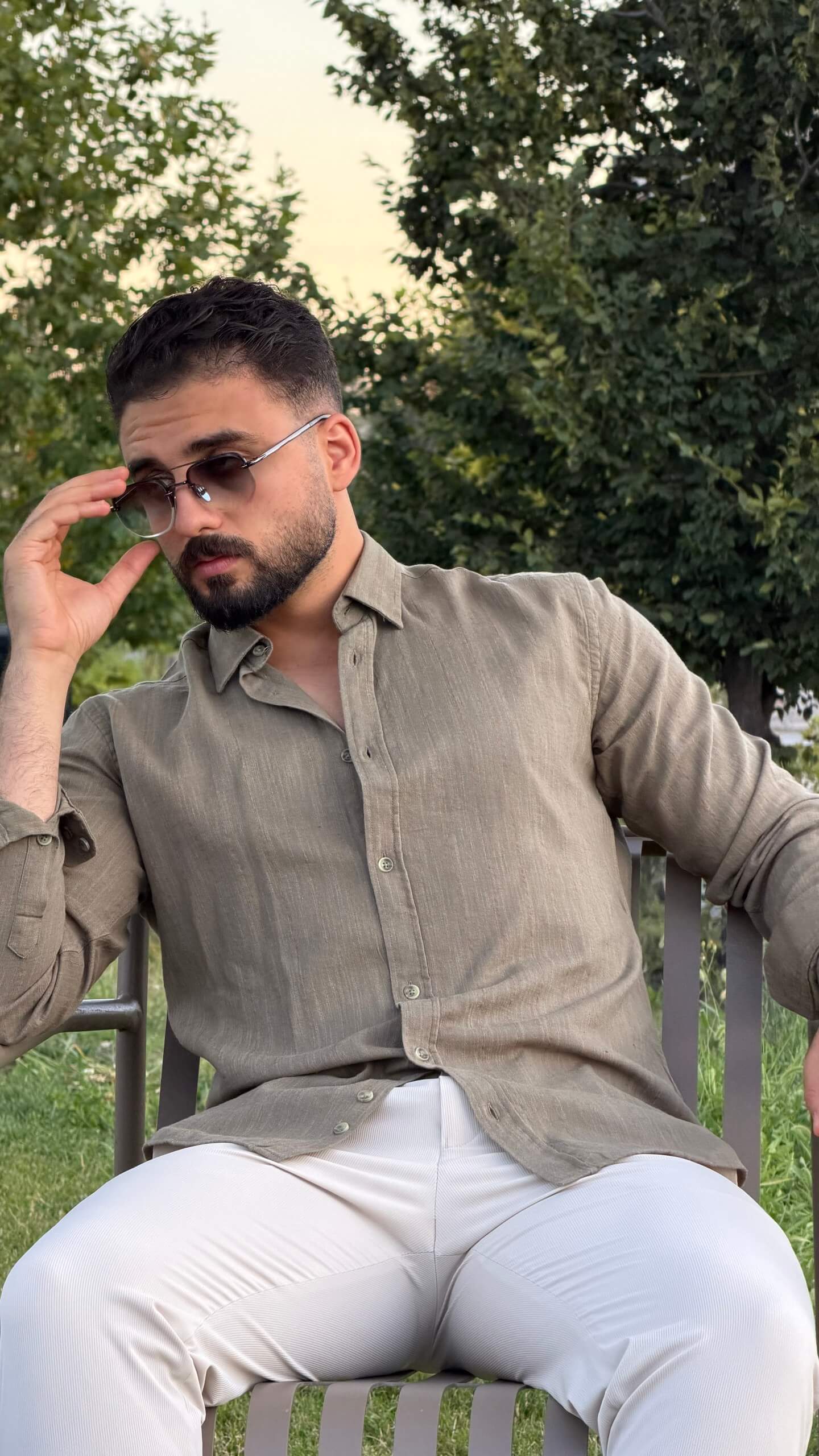 Men’s green textured cotton long sleeve casual shirt styled with white trousers for a smart casual outfit
