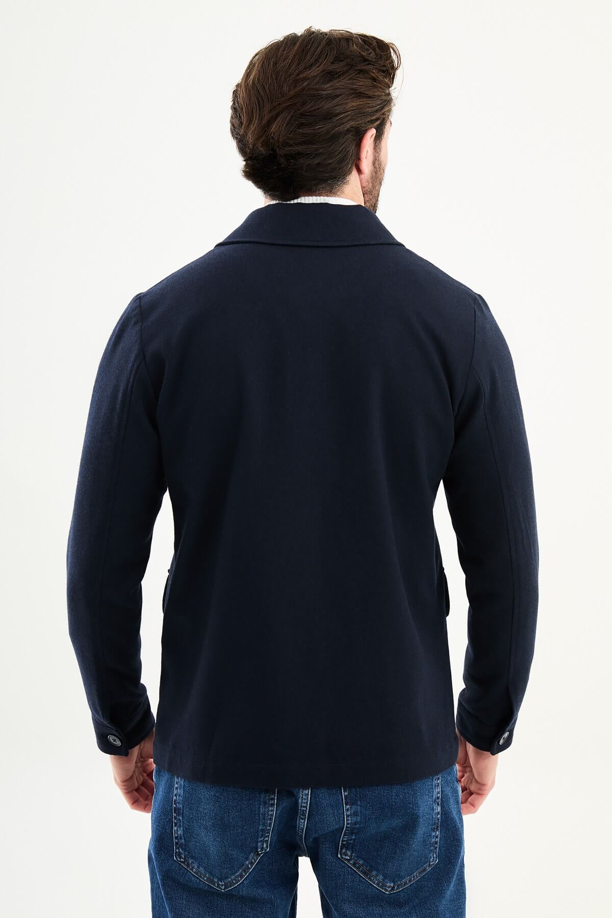 Men’s navy blue wool blend utility jacket with button-up front and four pockets, regular fit smart casual layering jacket styled with blue jeans and white turtleneck sweater