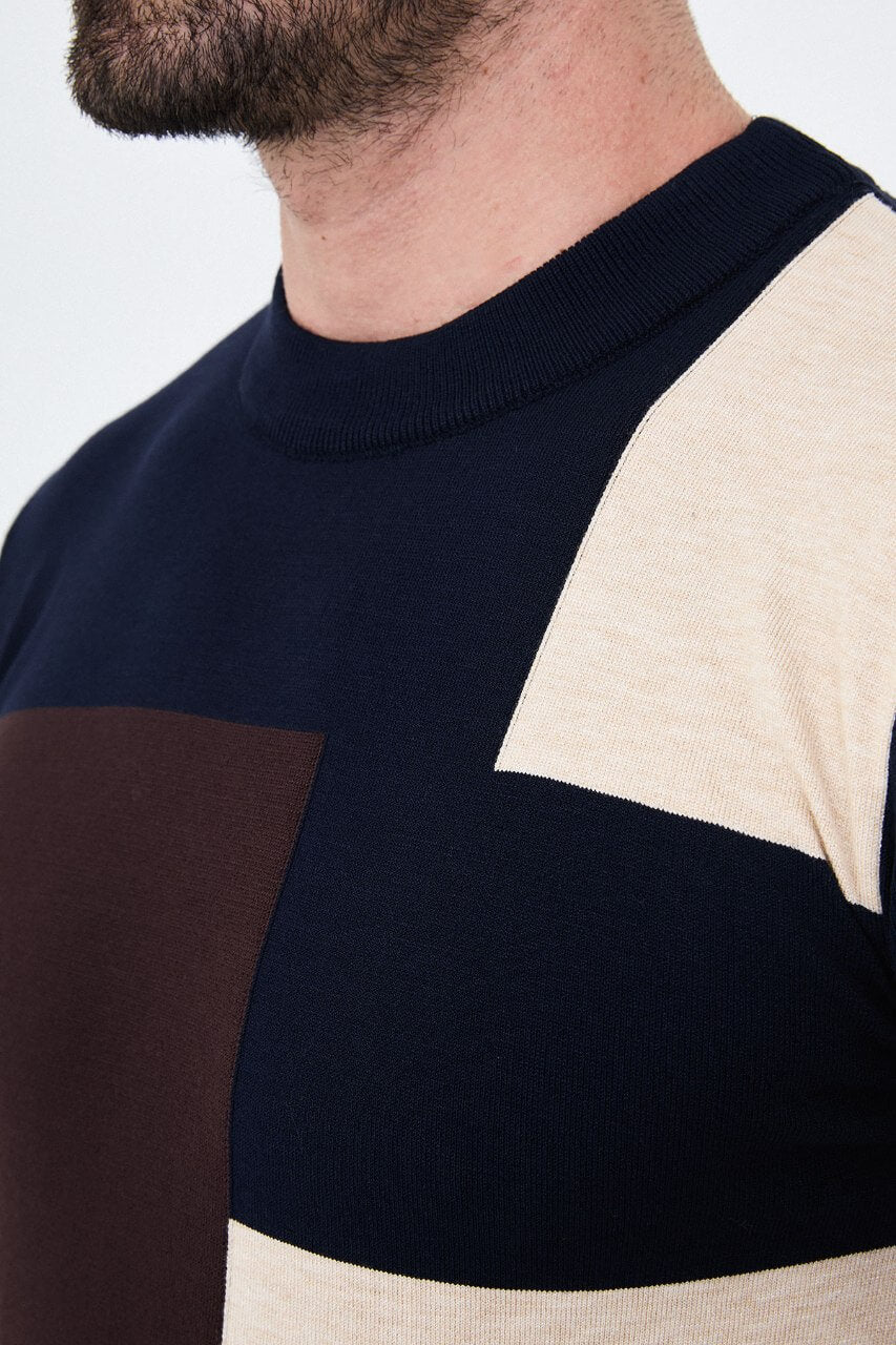 Men's navy blue crew neck sweater with dark brown and ecru geometric colour-block panels.