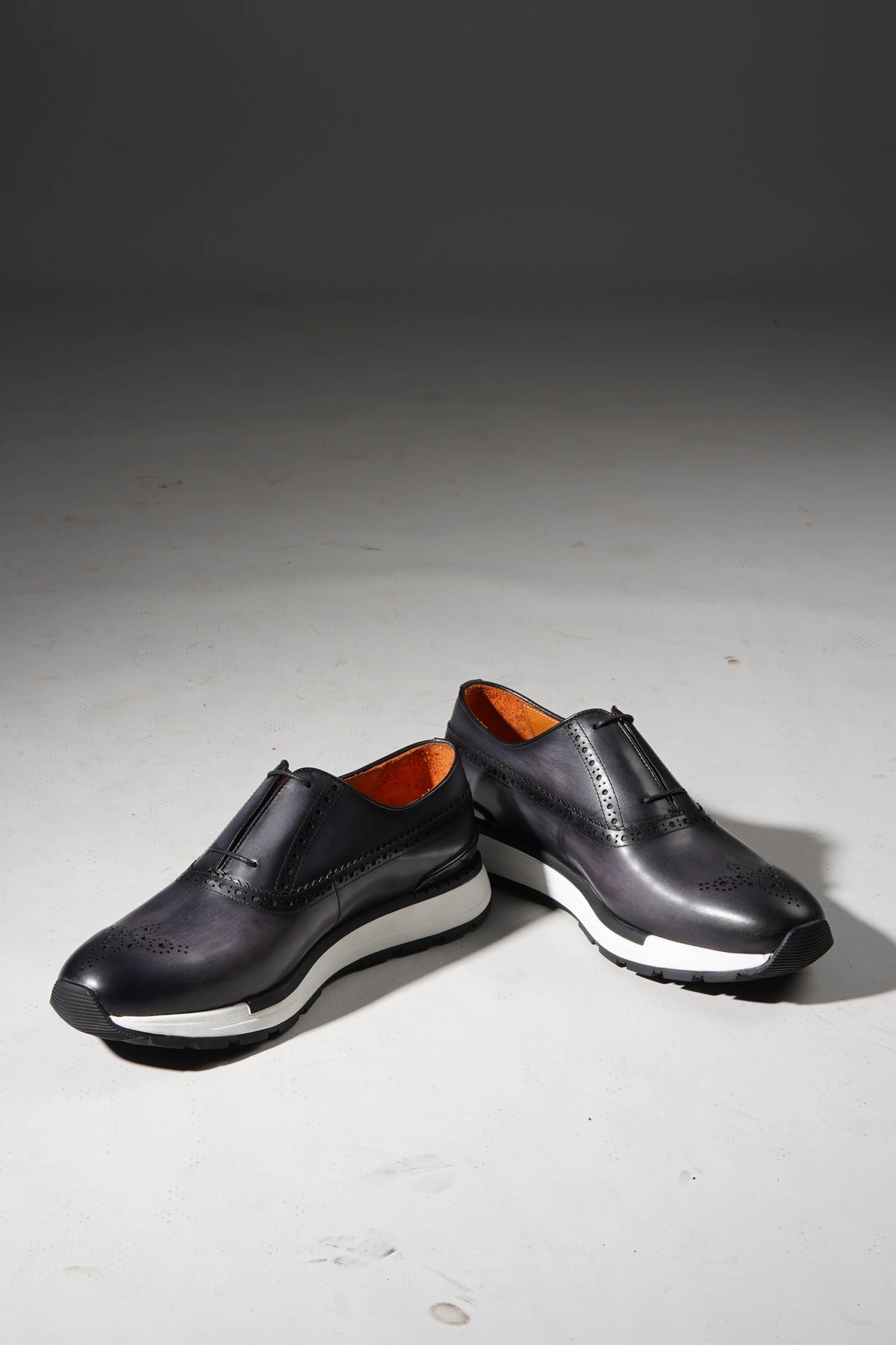 Men's navy cow leather sneaker with brogue perforations, front view