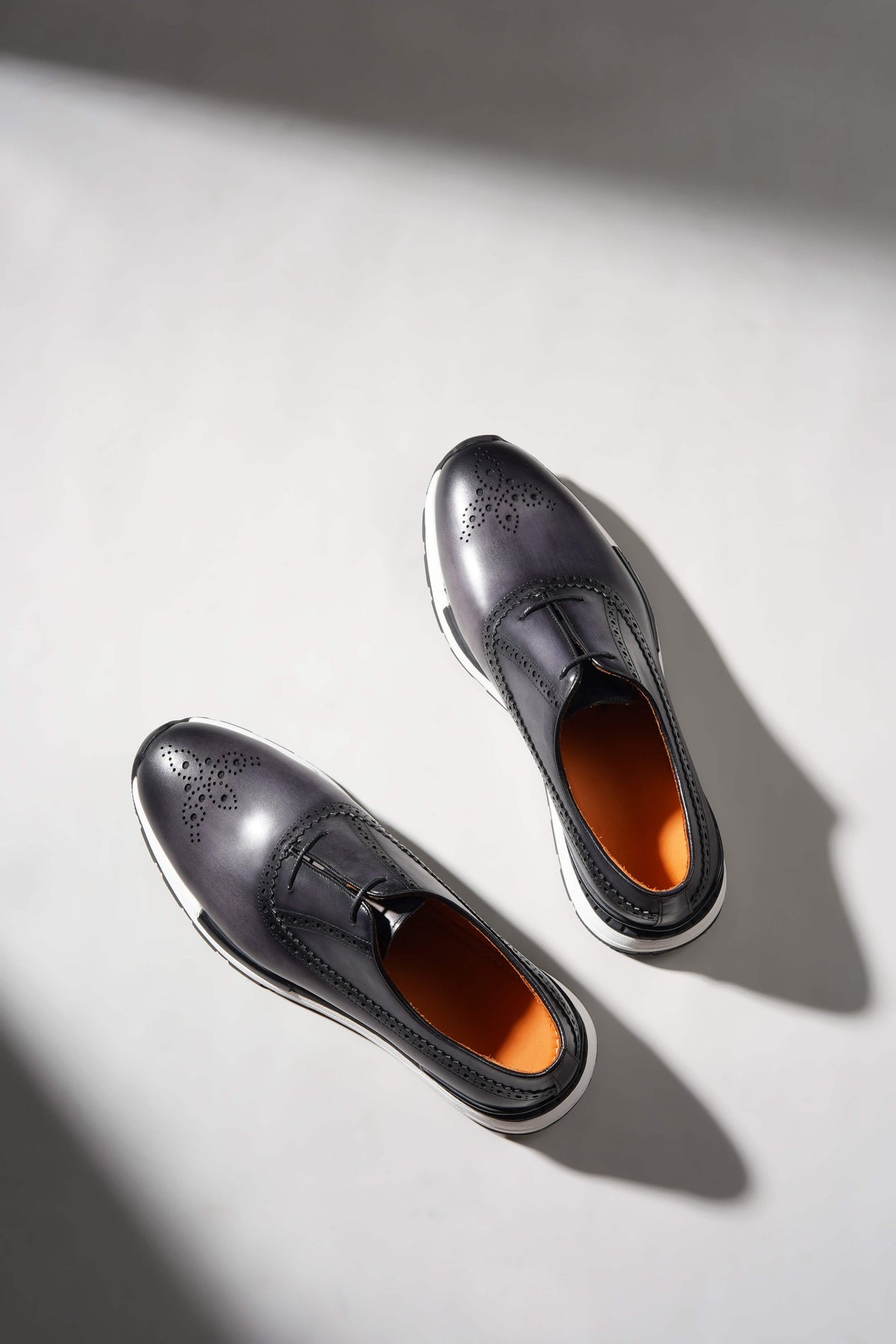 Navy leather sneaker brogue detailing, close-up