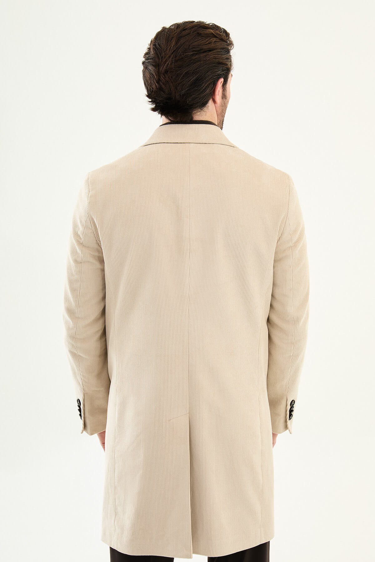 Beige double-breasted men’s coat styled with dark turtleneck sweater