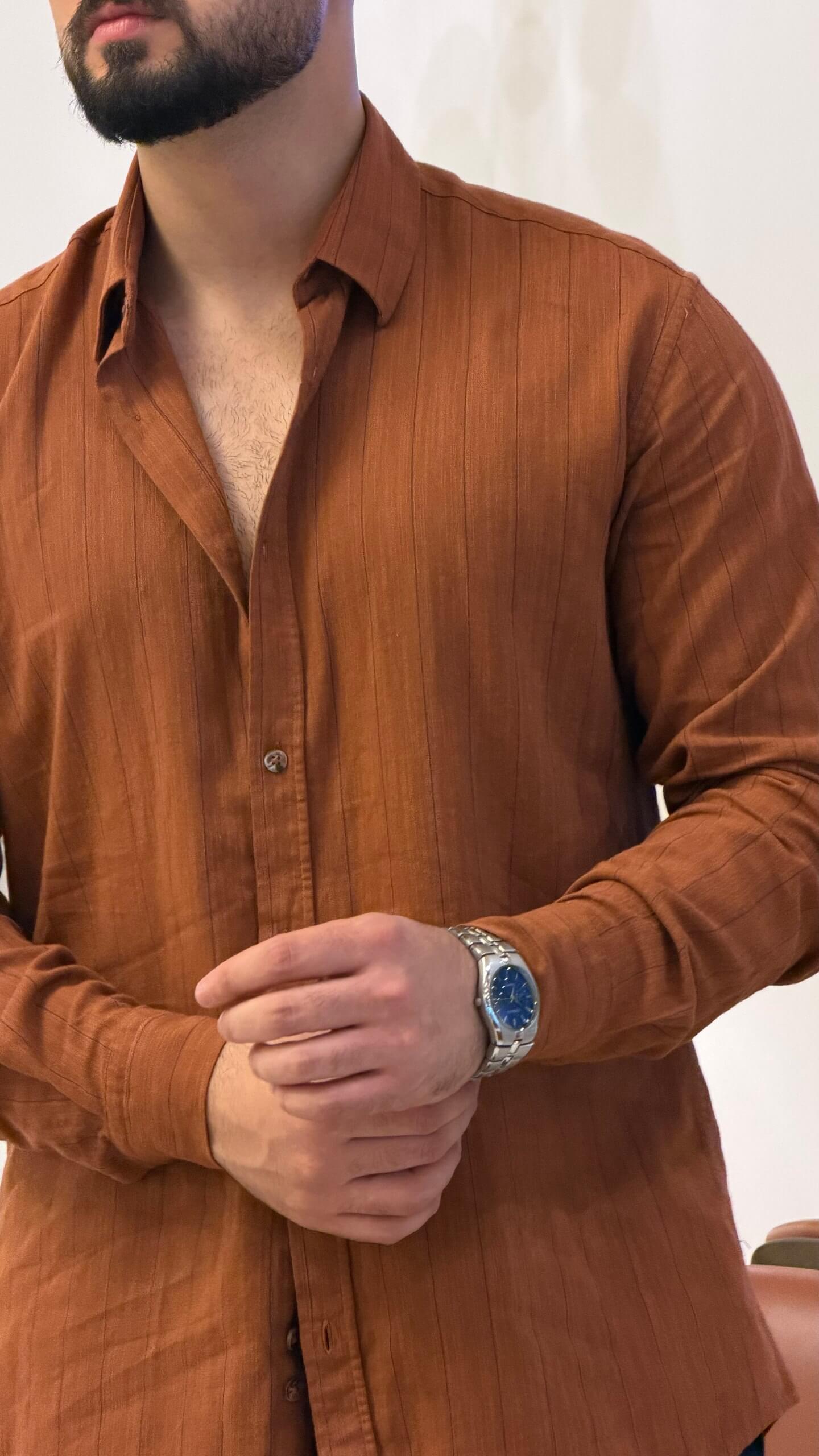 Men’s tile brown long sleeve cotton button-up shirt styled with black trousers and brown sneakers