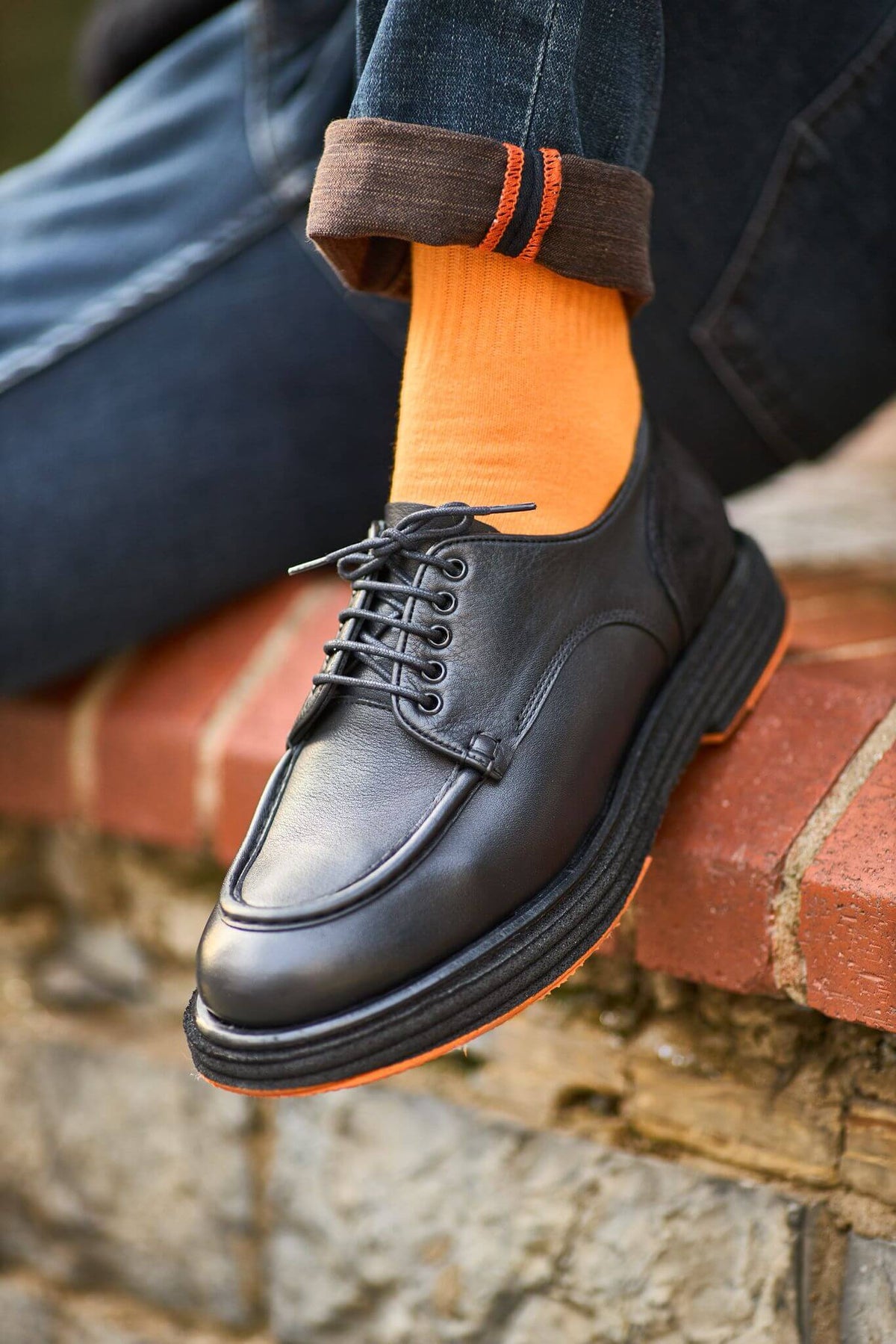 Men’s black leather derby shoes with moc-toe stitching and suede heel detail