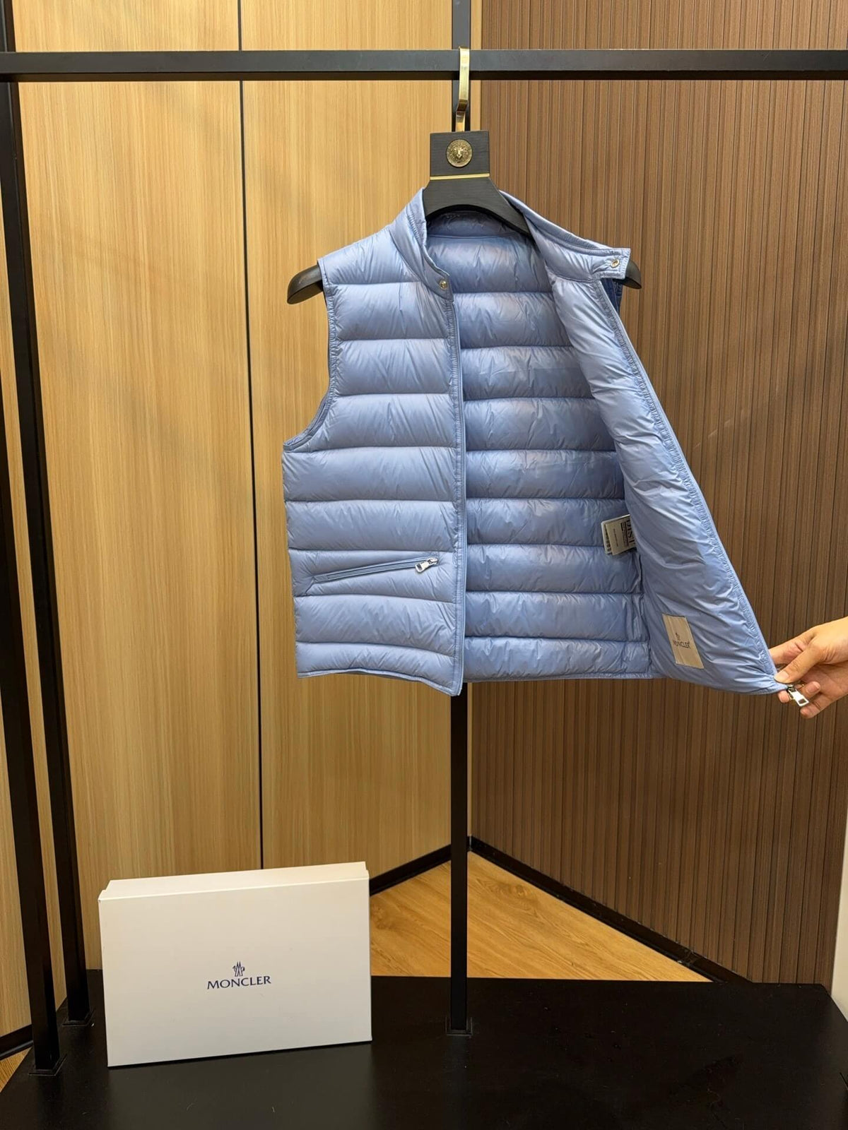 Light blue glossy down vest with chest logo patch and quilted panels, Moncler Gui-inspired.