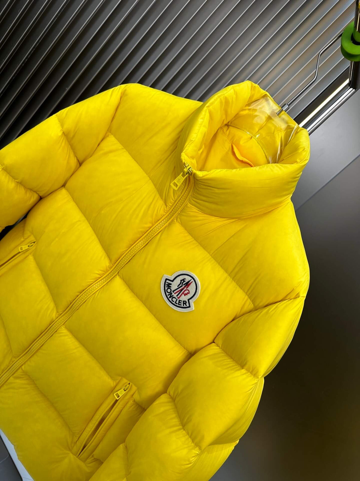 Moncler-inspired Maya yellow short down jacket displayed open on stand with glossy finish.