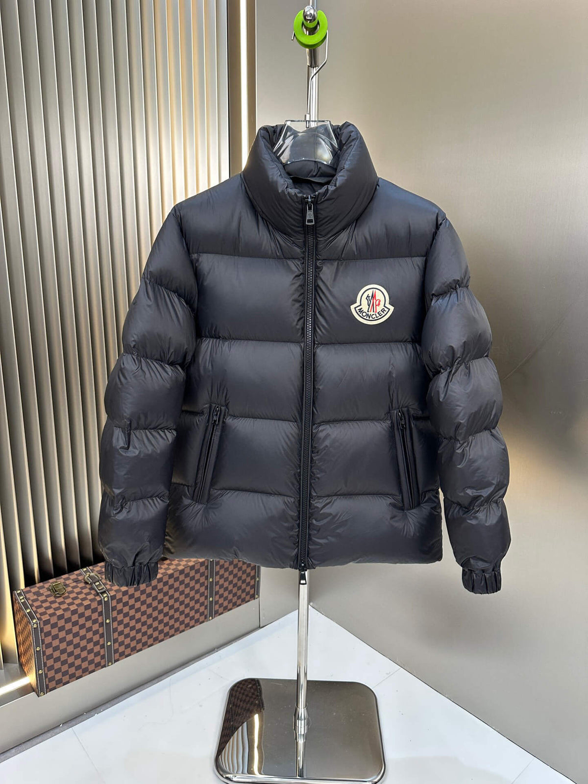 Black shiny down puffer jacket with hood and high collar, Moncler-inspired design, front view on mannequin.