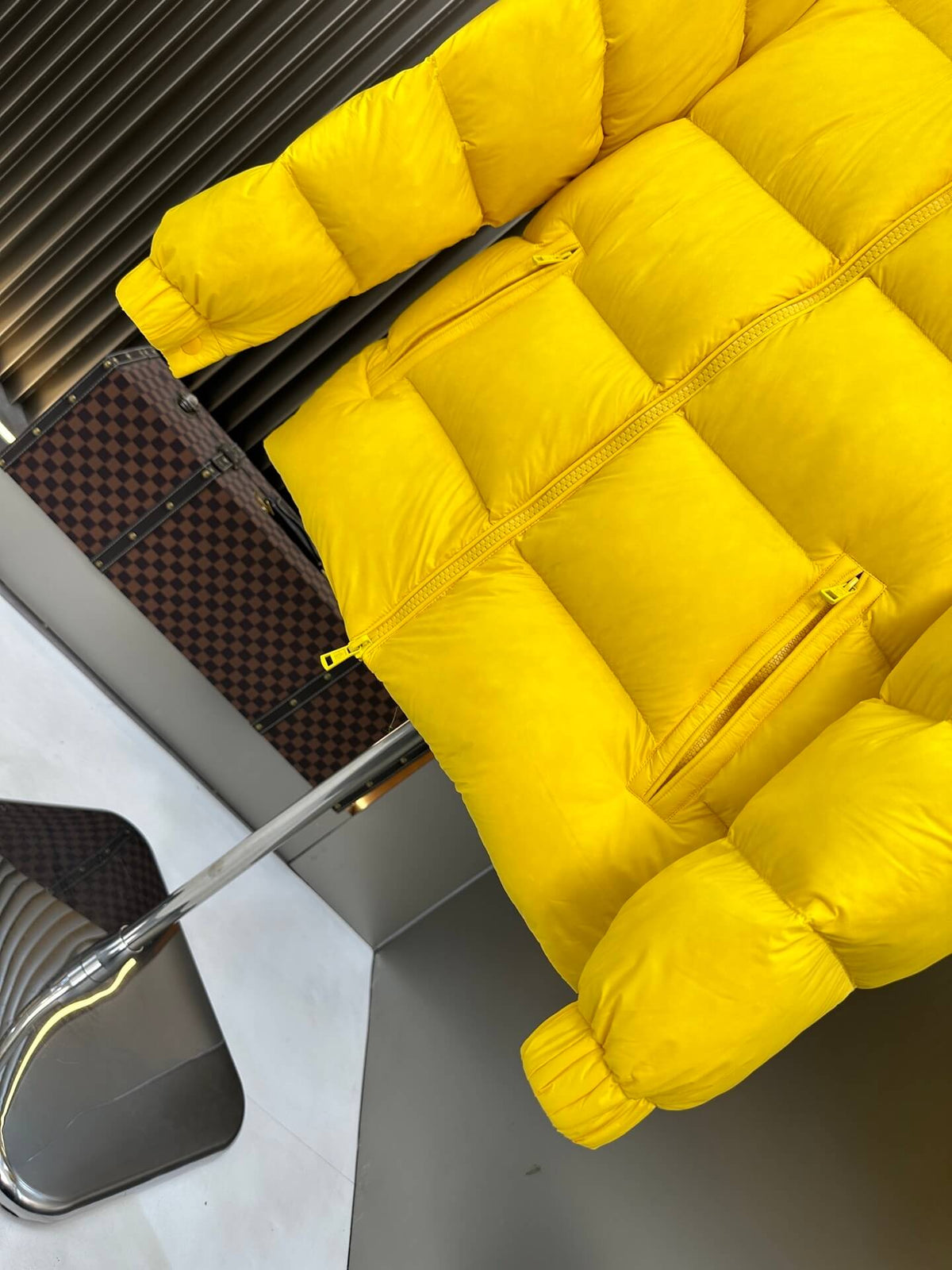Moncler-inspired Maya yellow short down jacket displayed open on stand with glossy finish.