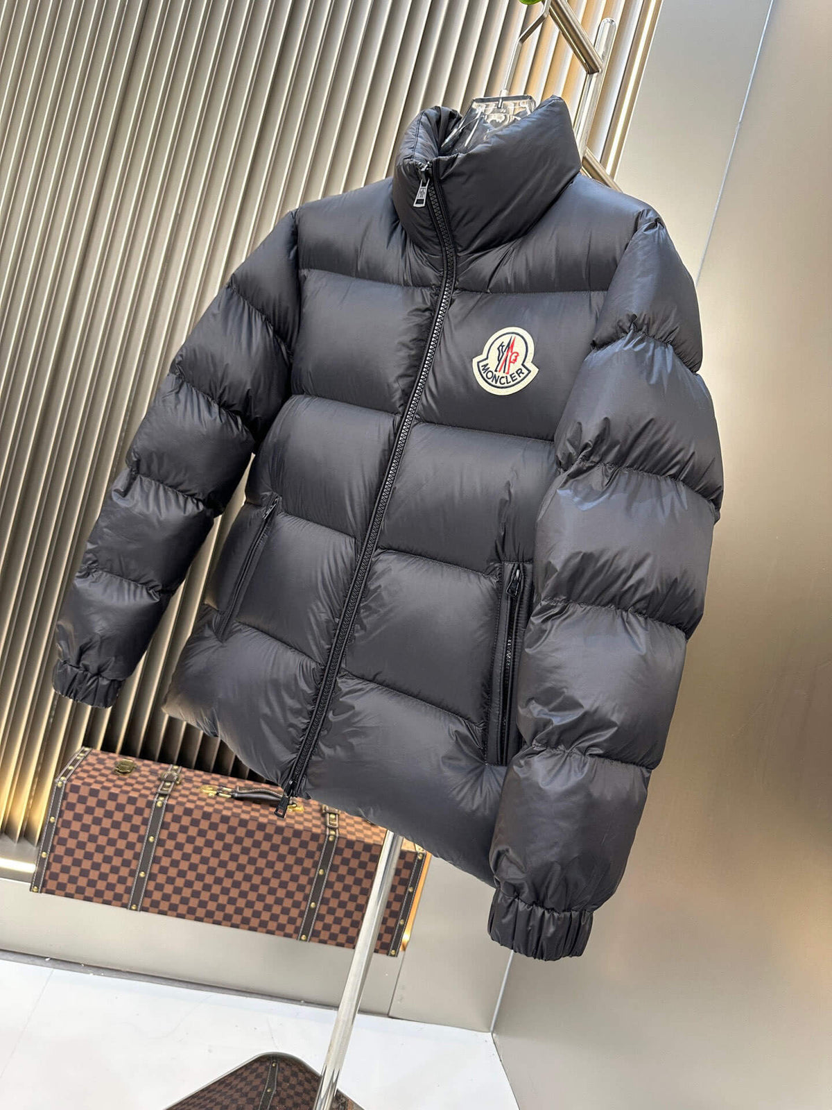 Black shiny down puffer jacket with hood and high collar, Moncler-inspired design, front view on mannequin.