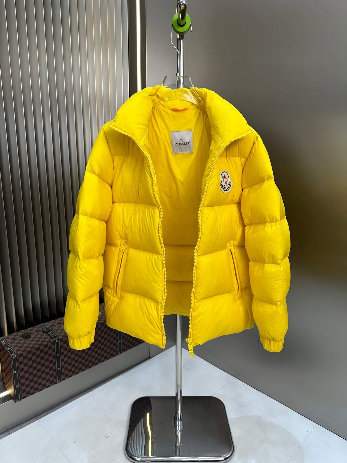 Moncler-inspired Maya yellow short down jacket displayed open on stand with glossy finish.