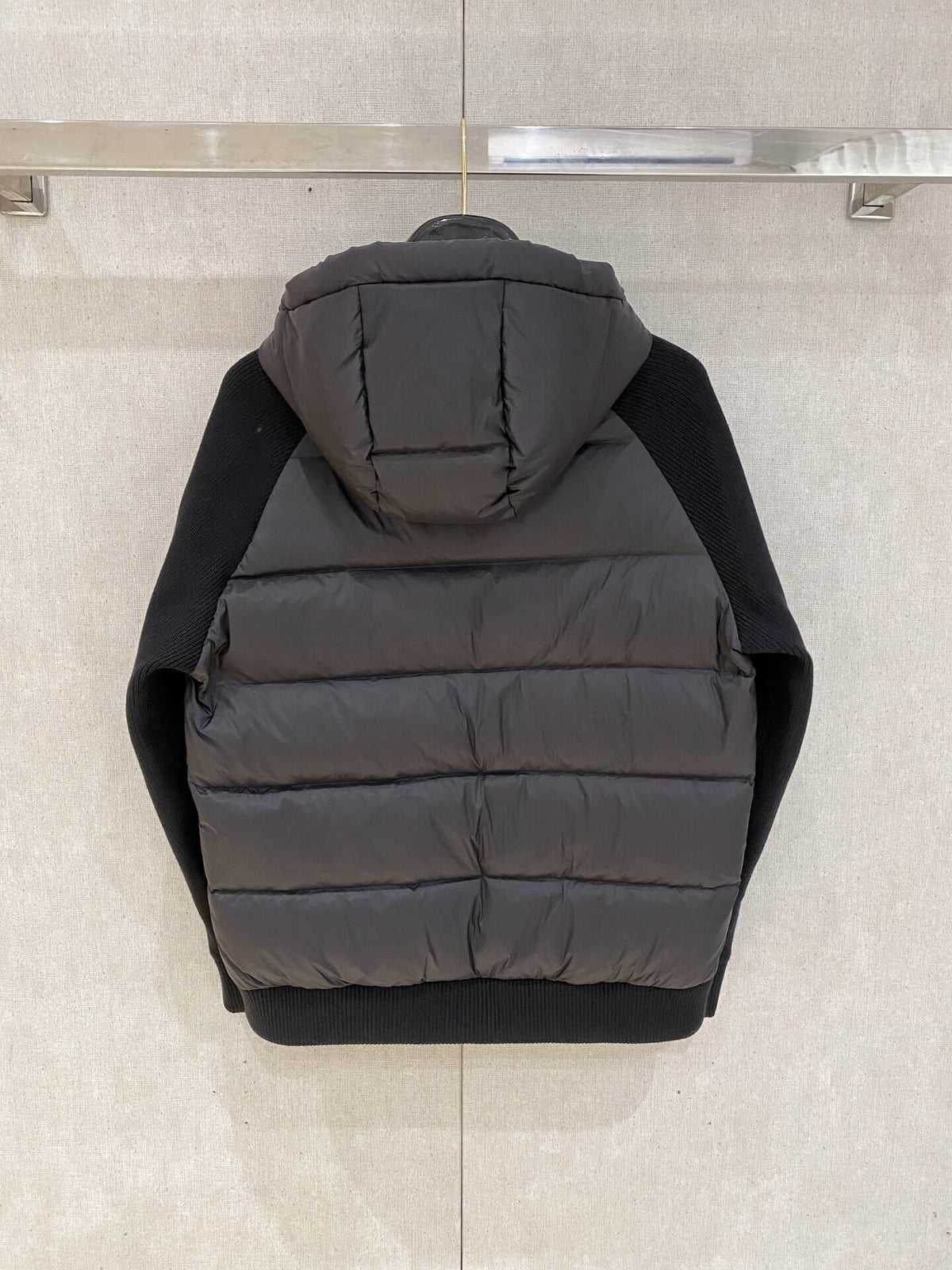 Black knit-sleeve down jacket with quilted front panels and hood, Moncler x Christopher Raxxy inspired design.