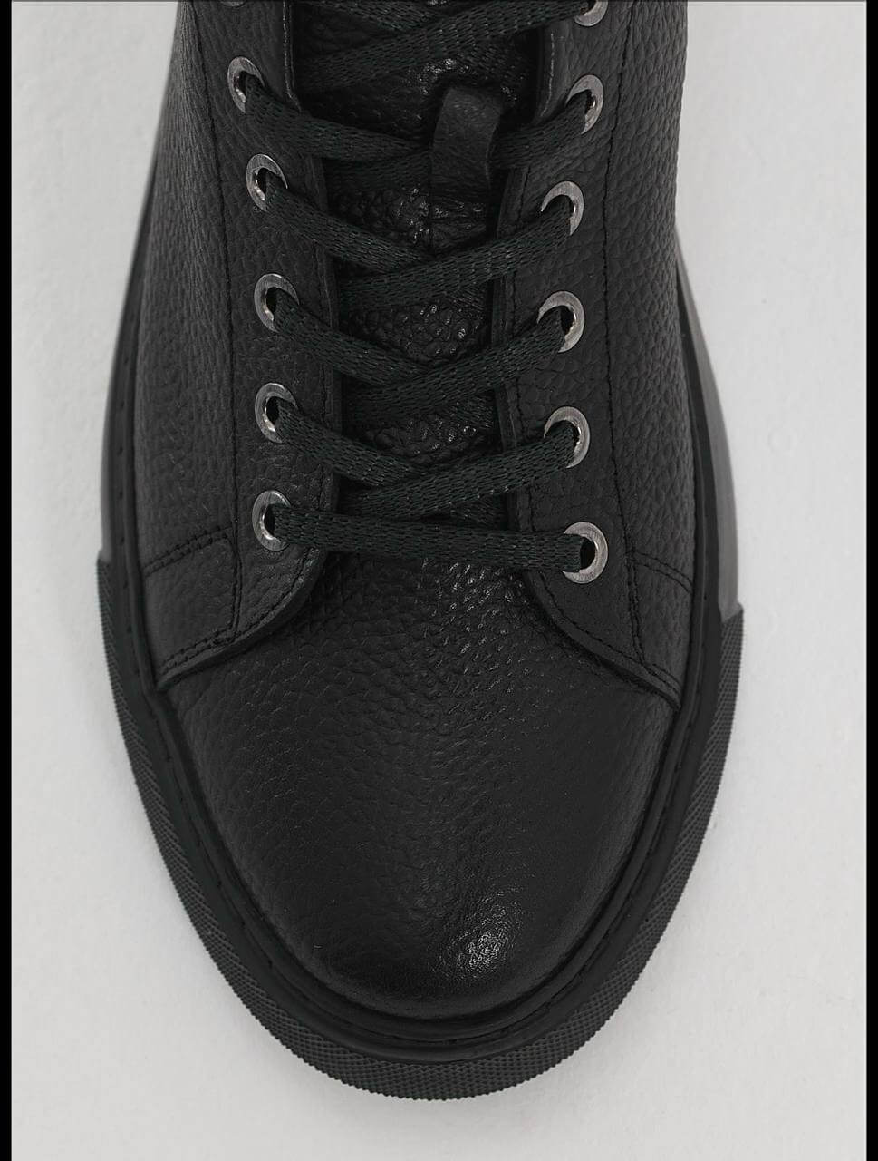 Black leather sneakers with textured floater leather and matching black EVA sole.