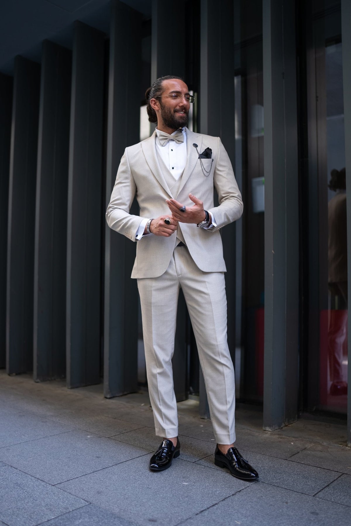 Beige tuxedo trousers and jacket pairing, lower outfit detail