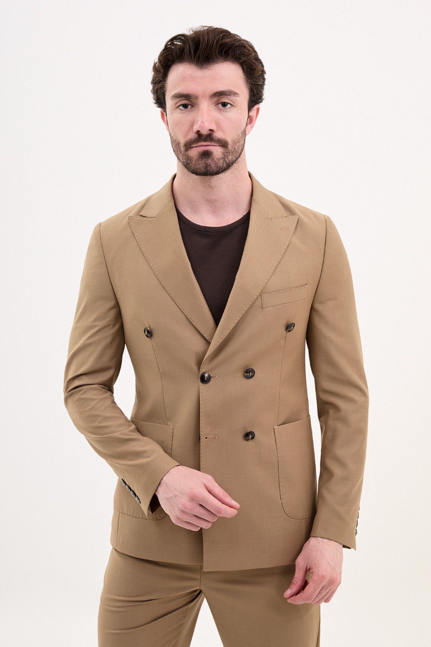 Man wearing a double-breasted camel suit from HolloMen’s Spring Summer Collection, paired with a casual brown shirt.