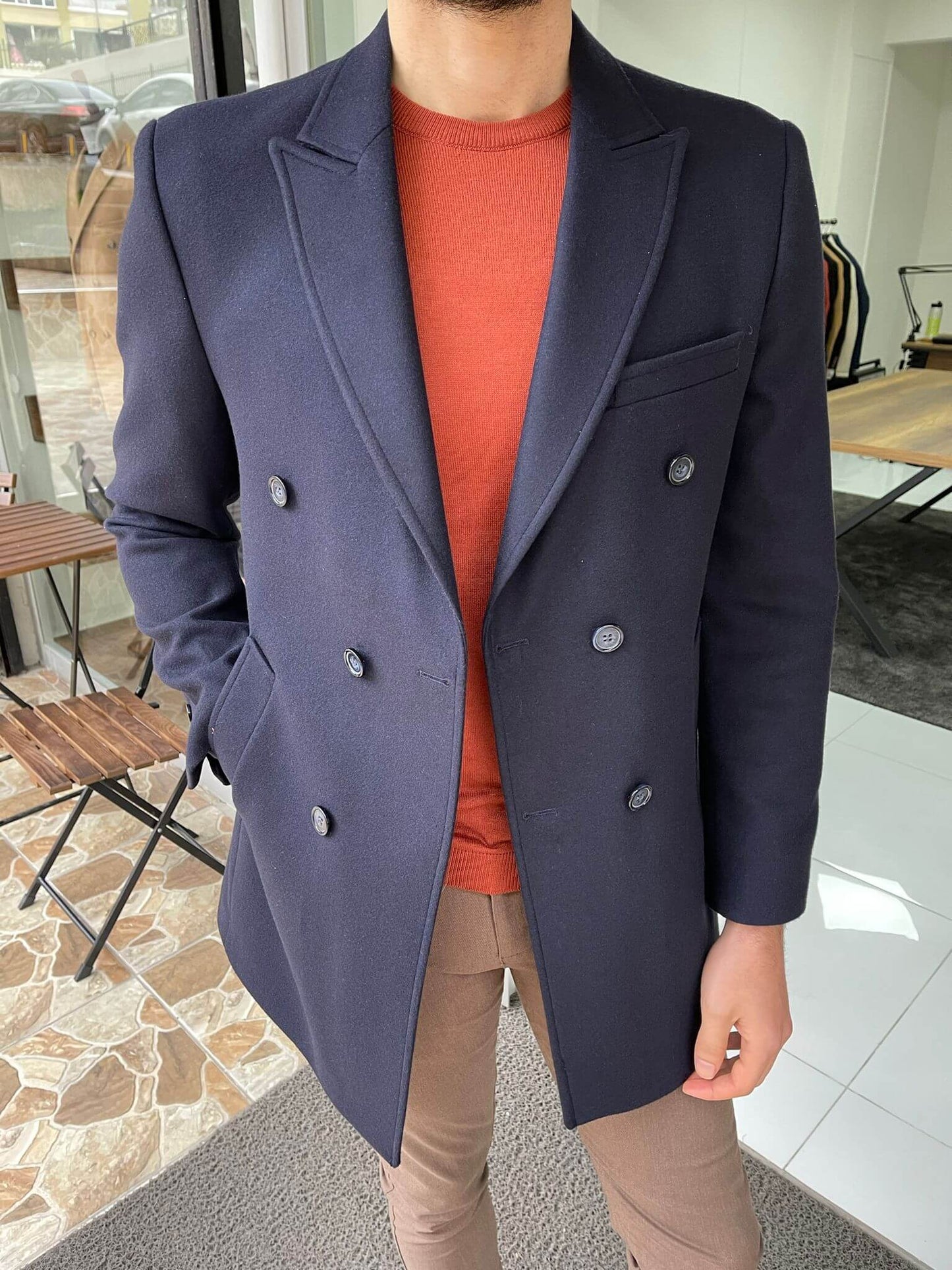 ouble-breasted navy blue wool coat, perfect for both casual and formal occasions