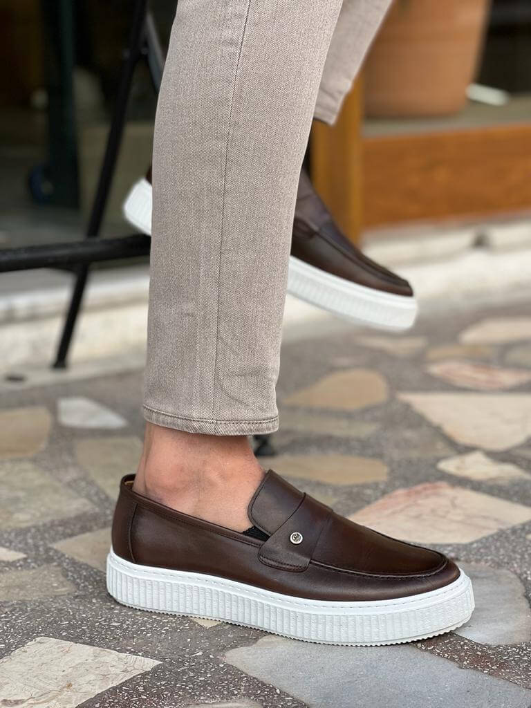 Rich brown leather penny loafers featuring a sleek silhouette and EVA sole, ideal for smart-casual and warm-weather styling.