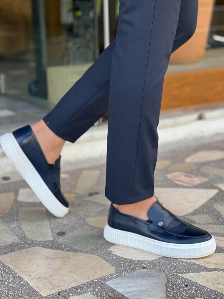Elegant navy blue penny loafers made from genuine leather, displayed with a minimalist design and EVA sole, suitable for casual and smart-casual occasions.