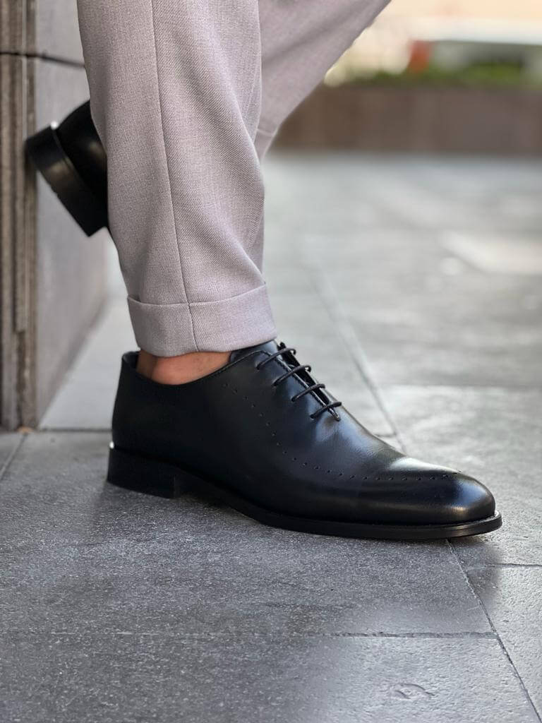 Sleek black leather Oxford shoes with a classic lace-up design and neo-lite sole, crafted for elegant formal and office wear.