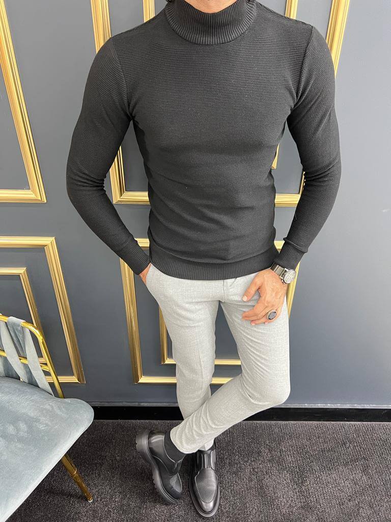 A black mock turtleneck with a smooth texture and a solid black color, making it a versatile and stylish addition to any outfit."