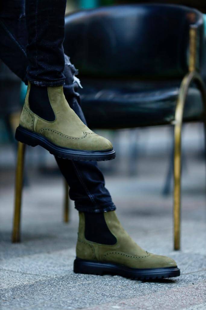 khaki nubuck Chelsea boots with elastic sides and black rugged soles, styled with black distressed jeans.
