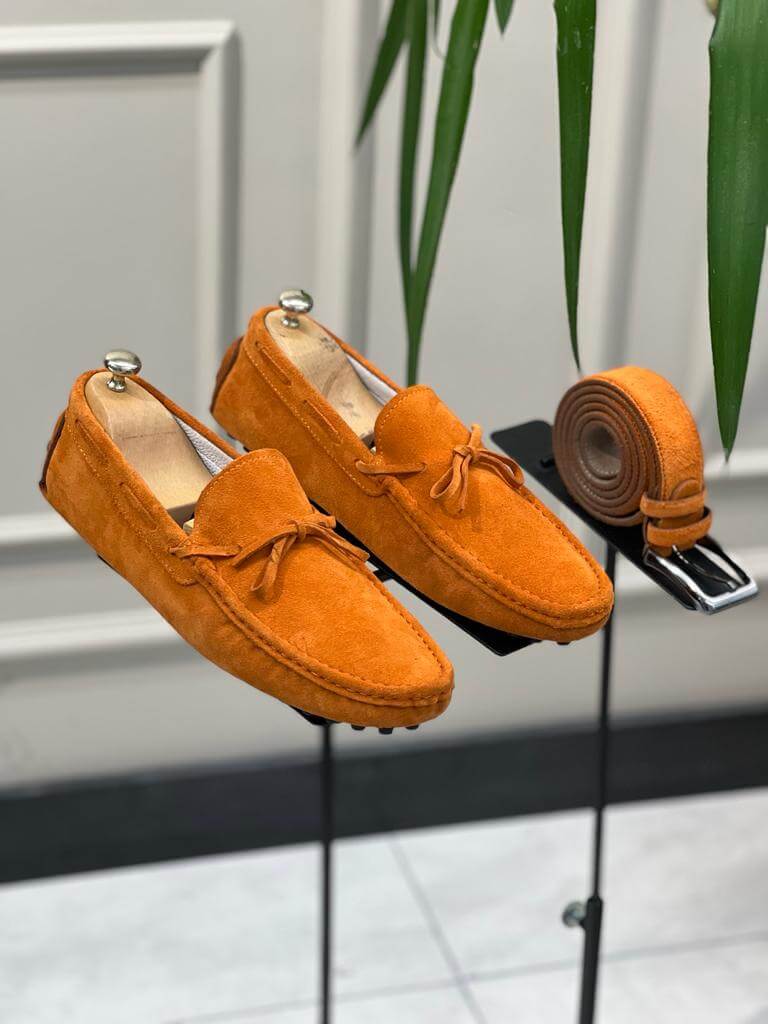 Bright orange leather casual loafers featuring a slip-on design and rubber soles, styled for vibrant spring and summer looks.